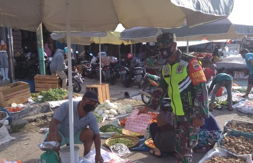 Agar Warga Taat Prokes, Sertu Purnomo Pasangkan Masker ke Warga